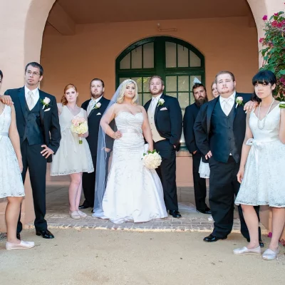 Bride and groom posing with bridesmaids and groomsmen in formal wedding attire