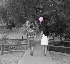 © 2019 RKS Photography | https://rksshots.com A couple walks hand in hand on a path in a park; the woman holds a pink balloon.