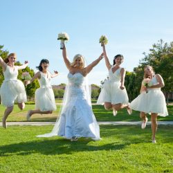 © 2019 RKS Photography | https://rksshots.com Bridal party jumping and posing for a photo outside on a sunny day